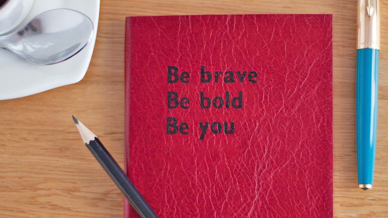 book on desk, word on the front say, be brave, be bold, be beautiful, be you